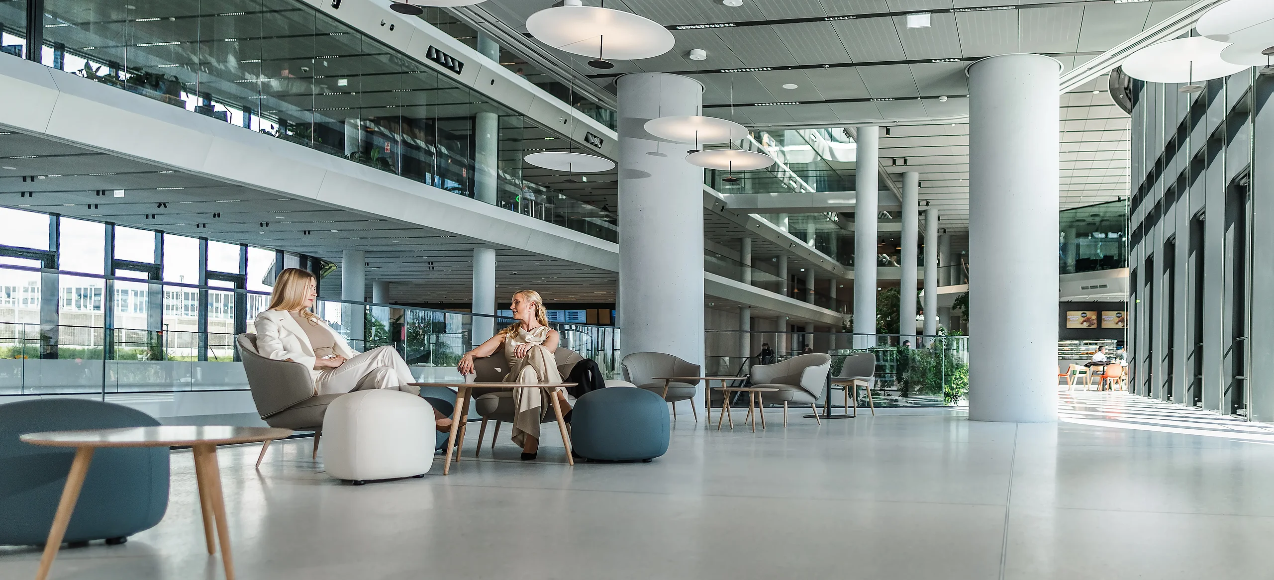 Modern interior lounge at MOL Campus in Budapest Bright modern lounge and meeting area inside MOL Campus with seating and open office spaces