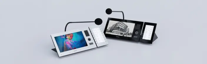 Modern Desktop Intercoms White and black desktop intercoms with screens and mics on grey background.