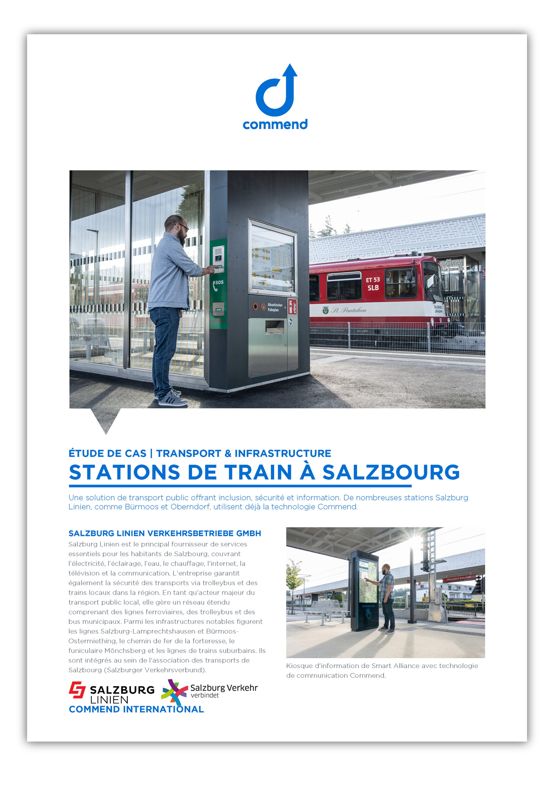 Man using an intercom at a train station info kiosk with a red train.