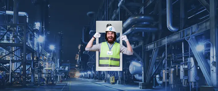Cheers! Intercom for Industrial Sites A cheerful worker in a hard hat appears from a modern intercom at a large industrial facility.