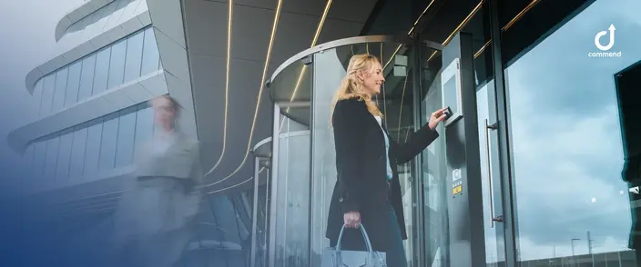 Modern Intercom for Building Access Woman using a modern digital intercom at a corporate building's main entrance.