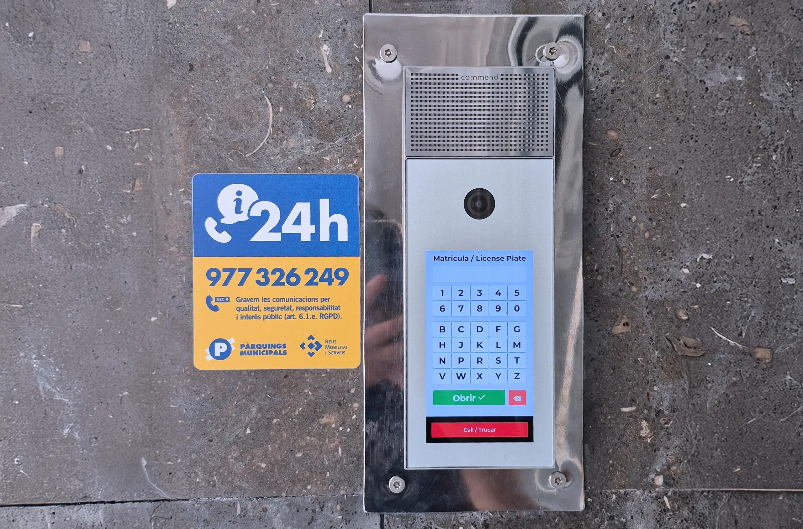 Intercom panel with camera and licence plate keypad at parking entrance