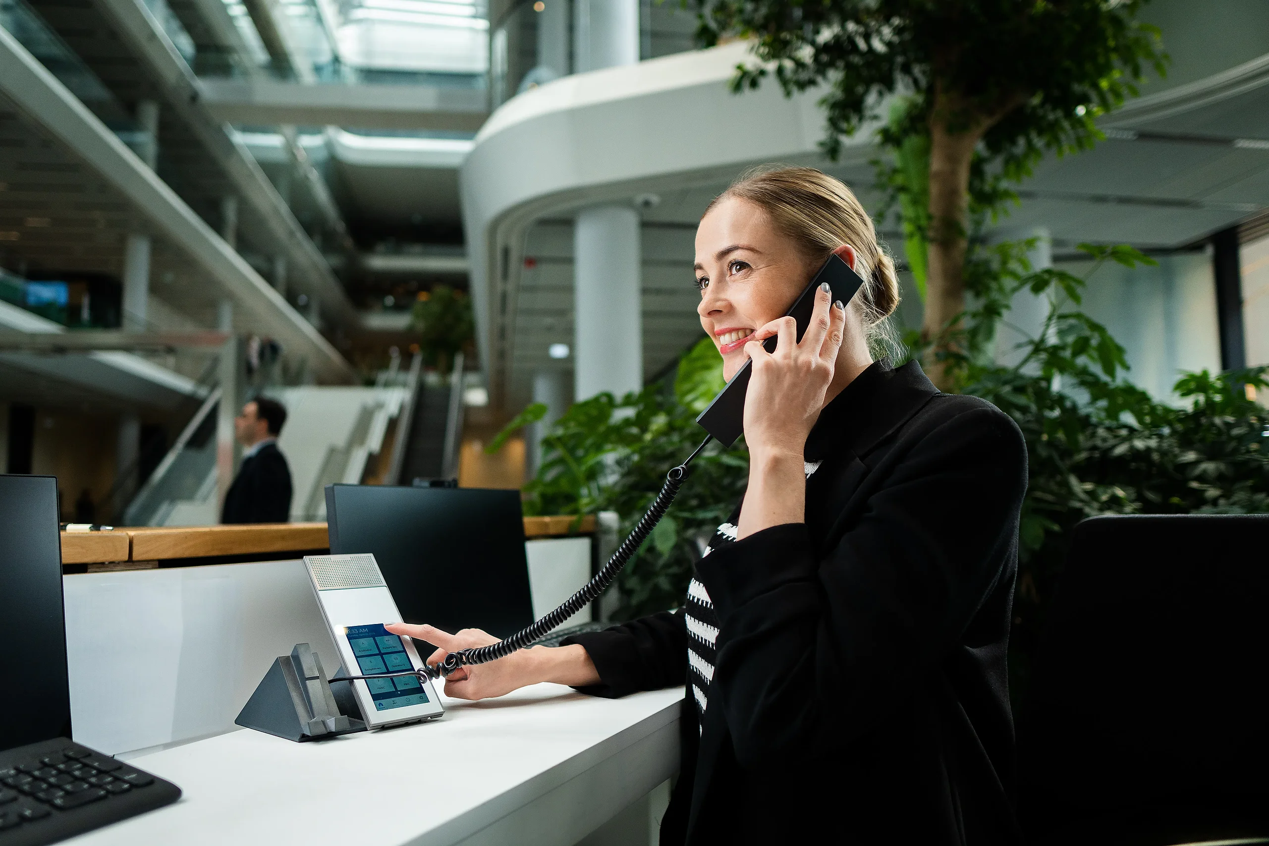 Intercom communication terminal at MOL Campus reception Receptionist using an Intercom communication terminal at the MOL Campus reception desk