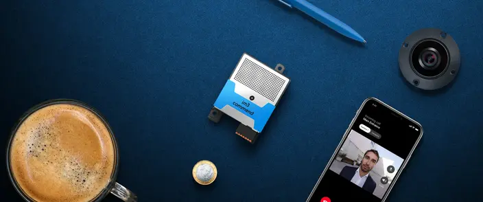 Smart Intercom for Modern Security Commend im3 communication module, smartphone with video call, camera, coffee, pen on blue.
